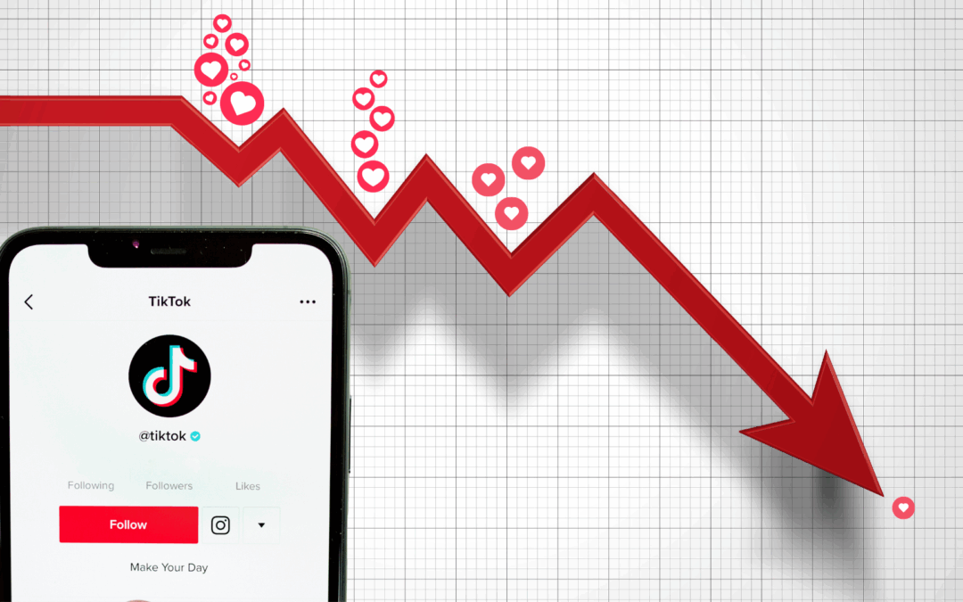A smartphone displaying TikTok’s profile page in front of a downward-trending red arrow, with falling heart icons symbolizing declining engagement.