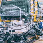 Automotive factory workers assembling a truck on a modern production line to improve efficiency and streamline manufacturing processes.